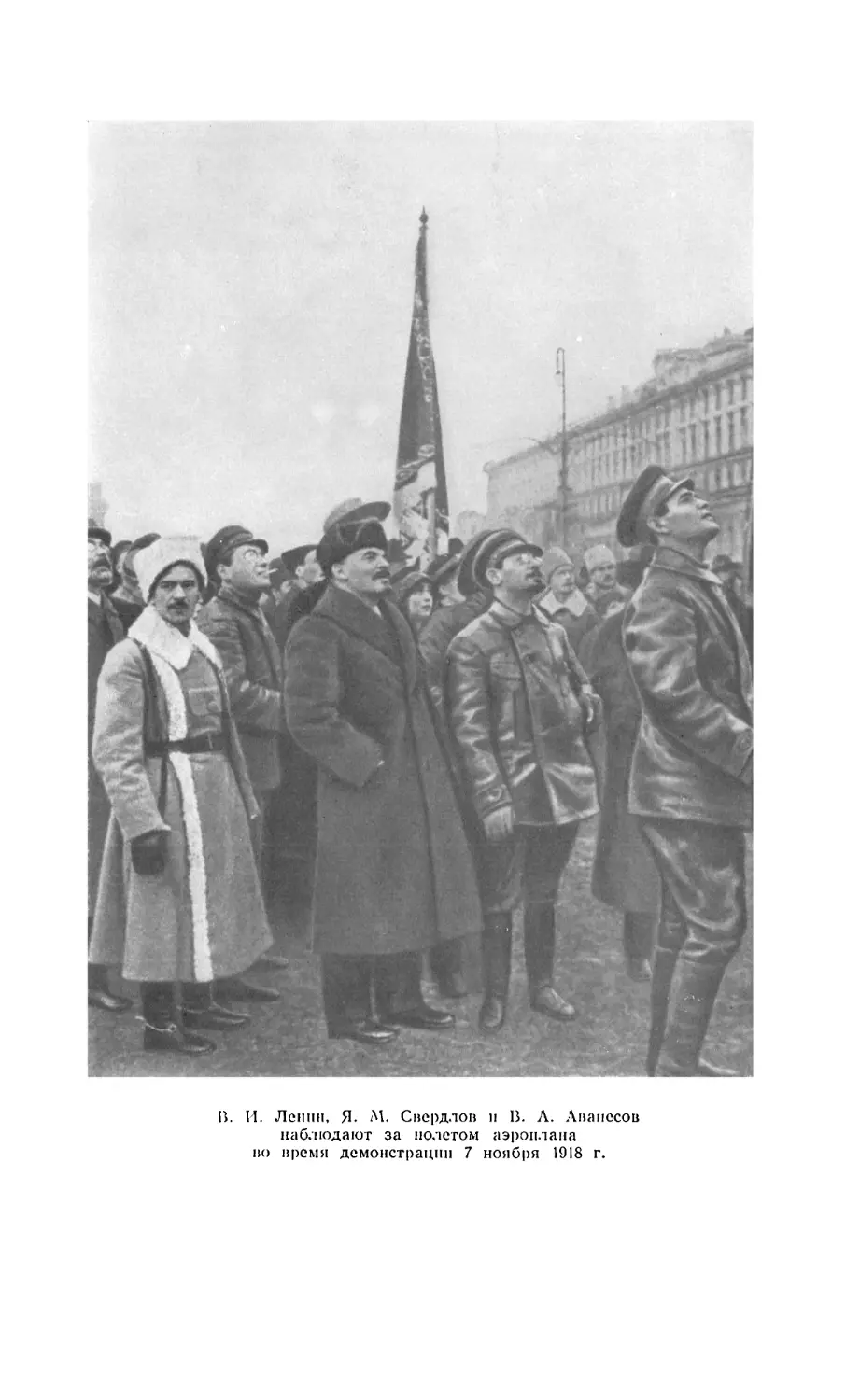 В. И. Ленин, Я. М. Свердлов и В. А. Аванесов наблюдают за полетом аэроплана во время демонстрации 7 ноября 1918 г